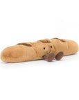 Peluche Amuseables Baguette Jellycat, de profil, couchée