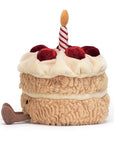 Peluche Amuseables Birthday Cake Jellycat, de profil, avec ses bottines
