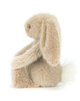 Peluche Oat Flufflet Bunny Jellycat, de profil, aux oreilles tombantes