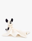 Doudou Bashful Black & Cream Puppy Soother Jellycat, doudou posé sur sa couverture